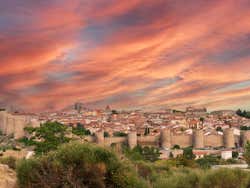 View of Avila under a red cloudy sunset sky