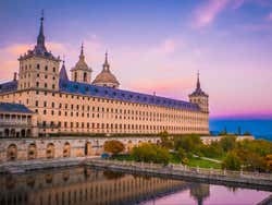 Real Monasterio de San Lorenzo de El Escorial under a purple sky