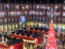 Plaza Mayor at Christmastime with a red lit up Christmas tree